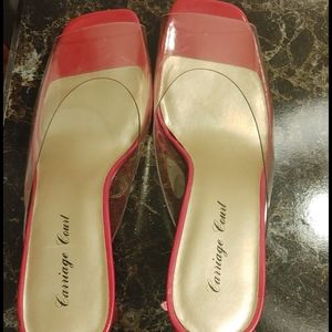 A Clear open toe shoe with a touch of Red